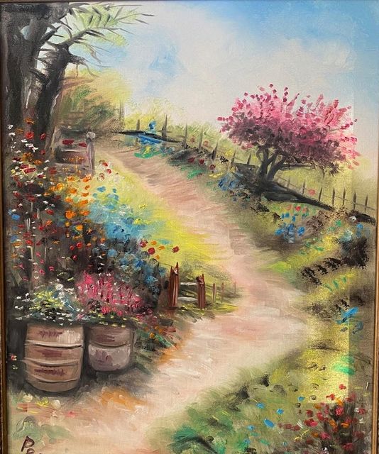 A garden path past rain barrels toward a pink flowering tree